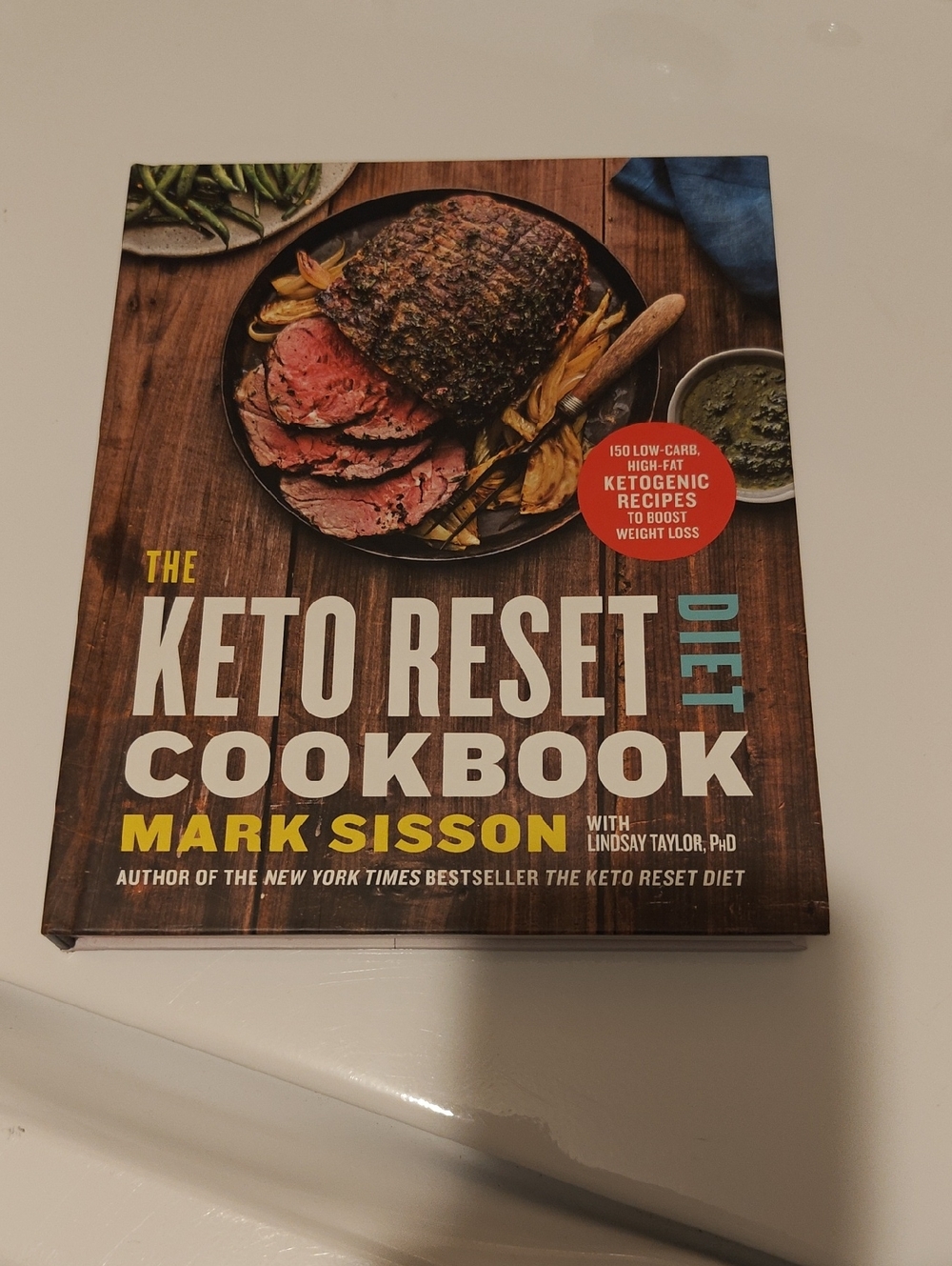 The Keto Reset Diet Cookbook by Mark Sisson - Brown Wood Cover with Food Photo